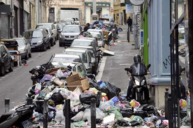 A child rides his scooter in front garbage piled on October 24, 2010 in a street of Marseille, as a result of a strike by rubish collectors since October 12 to protest against French President&apos;s bid to raise the retirement age. The pensions reform bill was approved by the Senate on October 22, and the text will be reconciled October 25 with the draft passed earlier by the lower house. However, strikes have continued across the industry. [Xinhua] 