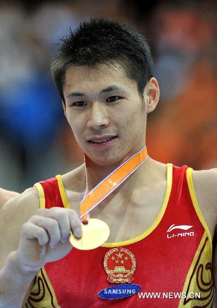 Zhang Chenglong of China displays his gold medal during the awarding ceremony for the horizontal bar final at the 42nd Artistic Gymnastics World Championships in Rotterdam, the Netherlands, Oct. 24, 2010. Zhang claimed the title of the event with a result of 16.166 points. (Xinhua/Zeng Yi)