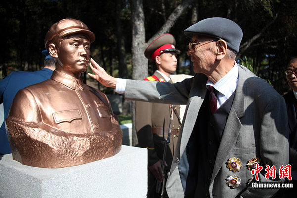 October 25, 2010 marks the 60th anniversary of the entry of the Chinese People's Volunteers (CPV) into the Korean War front in Pyongyang. In the photo CPV veteran Wang Hai, also former PLA Air Force Commander, cherishes the memory of martyrs before the bomb of Mao Anying, son of former Chinese Communist Party leader Mao Zedong. Mao Anying lost his life in the Korean War on Nov. 25, 1950.