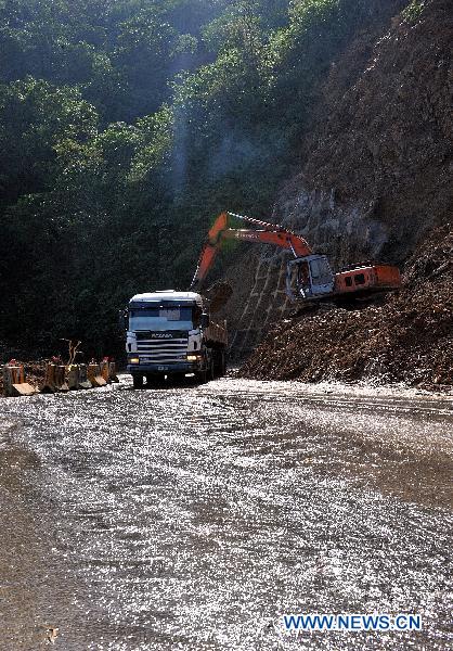 Rescuers work on the landslide-hit Suhua Highway in Taiwan, southeast China, Oct. 24, 2010. The rain-triggered landslides have left 11 people dead and 26 others missing, including 20 tourists from the Chinese mainland.