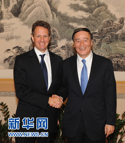 Chinese Vice-Premier Wang Qishan meets with U.S. Treasury Secretary Timothy Geithner at Qingdao airport, Shandong Province, on Oct. 24, 2010, during a stop-off for Geithner after he attended a two-day meeting of G20 finance ministers and central bank governors, which ended on Oct. 24, in Gyeongju, South Korea.