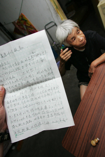 The one of letters of asking for help which writed by Gao Meiyun, 70, is seen at her home in Yang village of Shijingshan district on July 29, 2010 in Beijing, China. Gao, weight 37.5kg, for supporting her disabled son and retarded grandson has to deliver 40 - 60 containers water which per one weight 20kg every day. [sohu.com]