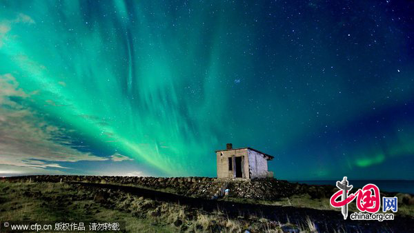 Aurora behind a little lighthouse dating back to the Second World War which has massive lights that were supposed to guide incoming ships and watch for hostile submarines in Seltjarnes, Iceland. [CFP]