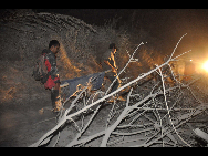 Rescue workers search for survivors after the Mount Merapi erupted in Indonesia, Tuesday, Oct. 26, 2010. Indonesia's most volatile volcano started erupting Tuesday, after scientists warned that pressure building beneath its dome could trigger the most powerful eruption in years. [Xinhua/AFP]