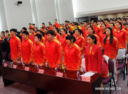 Athletes sing the Chinese national anthem during the establishing ceremony of the Chinese delegation for the 16th Asian Games in Beijing, Capital of China, October 26, 2010. 