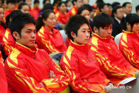 Badminton players Lin Dan (L) and Yu Yang (L2) attend the establishing ceremony of the Chinese delegation for the 16th Asian Games in Beijing, Capital of China, October 26, 2010. 