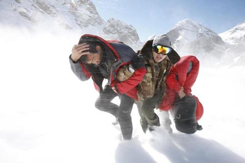 A rescuer help two stranded engineers to walk for the helicopter during a rescue in Tianshan Mountains area near Baicheng county of Aksu prefecture in Northwest China's Xinjiang autonomous region, Oct 27, 2010. [Photo/Xinhua] 