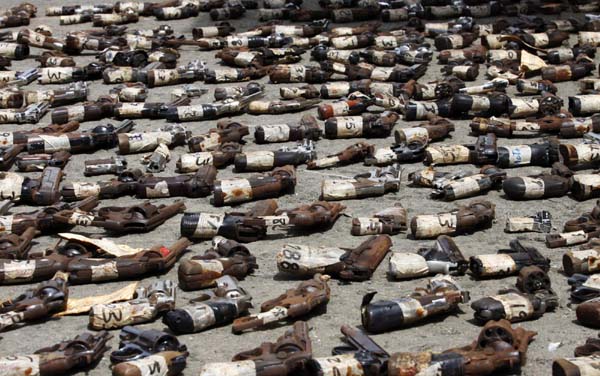 Illegal firearms meant for disposal are displayed before they are destroyed in Panama City. [China Daily/Agencies]