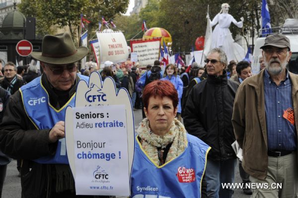 French workers take part in a demonstration against French President Nicolas Sarkozy's pension reform in Paris, France, Oct. 28, 2010. French trade unions greeted Parliament's adoption of the pension reform bill Thursday by launching a ninth wave of nationwide strikes and demonstrations.[Gonzalo Fuentes/Xinhua]