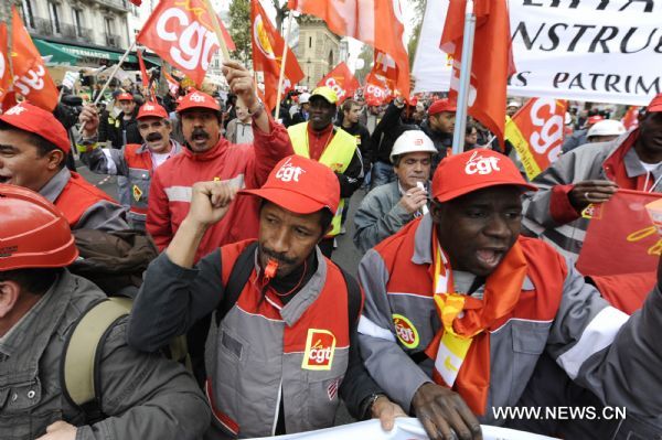 French workers take part in a demonstration against French President Nicolas Sarkozy's pension reform in Paris, France, Oct. 28, 2010. French trade unions greeted Parliament's adoption of the pension reform bill Thursday by launching a ninth wave of nationwide strikes and demonstrations. [Gonzalo Fuentes/Xinhua]