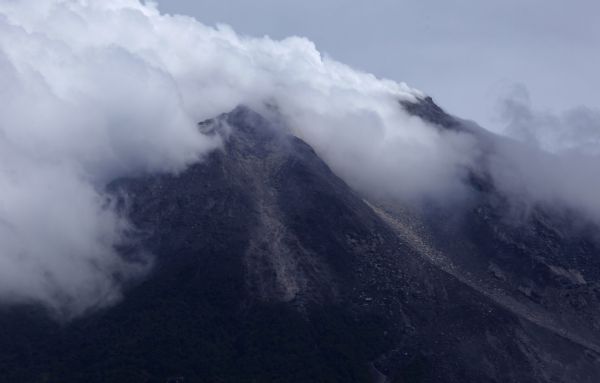 Caption Mount Merapi volcano emits smoke as it is seen from Kinahrejo village near Yogyakarta October 26, 2010. Indonesia's Mount Merapi erupted on Tuesday, prompting terrified villagers to flee and join the thousands already evacuated from its slopes. [Xinhua]