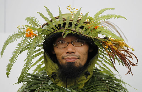 A Japanese environmentalist covered in leaves attends a peaceful human chain event outside the venue where the 10th Conference of the Parties to the Convention on Biological Diversity (COP10) is being held in Nagoya, central Japan, October 28, 2010.