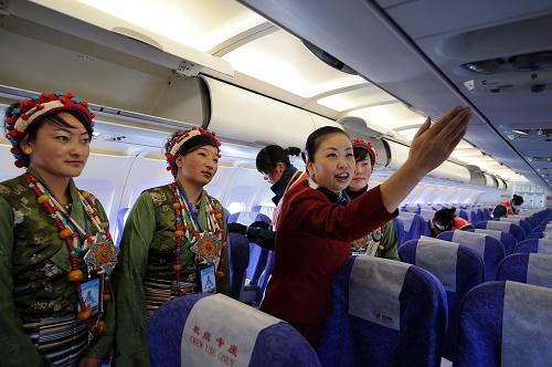 An air hostess shows some Tibetan women the interior of a plane of Air China that lands at Xigaze Airport in Xigaze, southwest China&apos;s Tibet Autonomous Region, on Oct. 30, 2010. Xigaze Airport opened Saturday, marking the launching of the fifth civil airport in Tibet. [Xinhua]