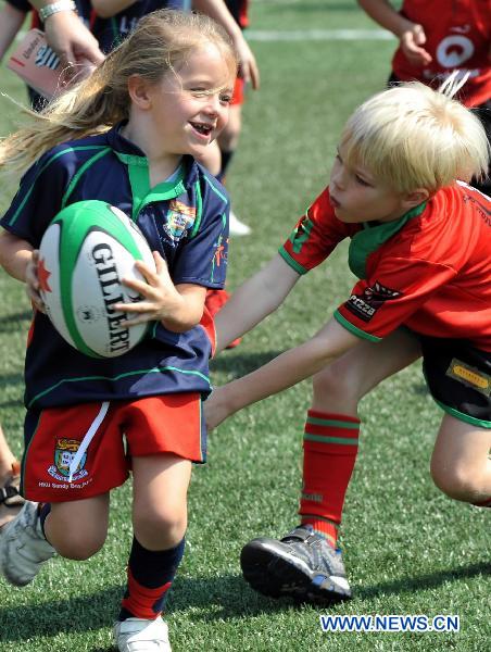 Young players compete in a rugby match in Hong Kong, south China, Oct. 30, 2010. About 3,000 players between the ages of four and 12 from countries and regions including Hong Kong of China, Singapore and Malaysia attended 410 rugby matches in Hong Kong from 9 a.m. local time (0100 GMT) to 2 p.m. local time (0600 GMT), breaking the current Guinness world record of 832 players from 95 teams. [Xinhua] 