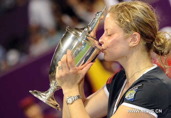 Kim Clijsters of Belgium kisses her trophy after defeating Caroline Wozniacki of Denmark in the WTA Tour Championships final match in Doha, Qatar, Oct. 31, 2010. (Xinhua/Chen Shaojin)