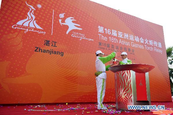 Guards remain the fire in flame lantern at the end of the torch relay for the 16th Asian Games in Zhanjiang City, south China's Guangdong Province, Nov. 1, 2010. (Xinhua/Liang Xu) 