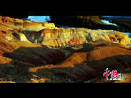 The World Heritage Committee decided to include China Danxia Landform in the World Heritage List at its 34th meeting being held in Brasilia, capital of Brazil, on Aug.1, 2010.  Photo shows the intoxicating Danxia Landform scenery in northwest China's Xinjiang Uygur Autonomous Region. [Photo by Wu Changqing]