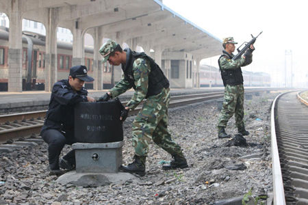 Armed soldiers and railway security forces defuse explosives along a railroad during a drill on October 31, 2010. A joint drill to guarantee security at the Asian Games in Guangzhou on November 12-27 was held by the railway police and the armed force in Huaibei, East China's Anhui province. In the drill, advanced devices were used to fight against terrorism and other threats. 