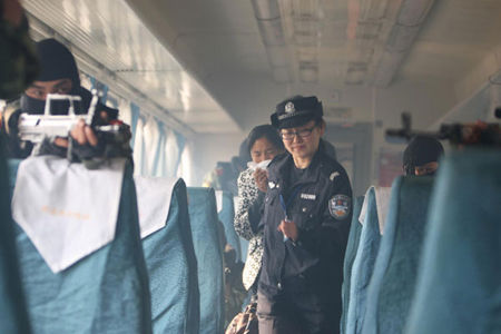 Passengers are led off the dangerous train by armed forces during an anti-terrorism drill in Huaibei, East China's Anhui province on October 31, 2010. 