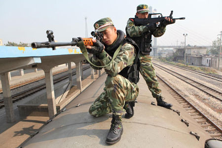 Armed soldiers hold their advantageous position during an anti-terrorism drill in Huaibei, East China's Anhui province on October 31, 2010. 