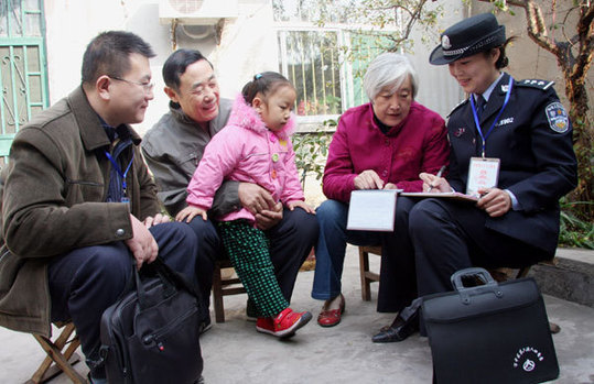 A census taker checks information collected in a trial run of the sixth national census, at a household in the city of Zaozhuang, east China's Shandong Province, on October 30, 2010. 