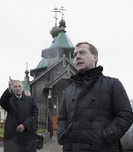 Russia's President Dmitry Medvedev (R) and Sakhalin region Governor Alexander Khoroshavi talk in front of a church on Kunashiri Island