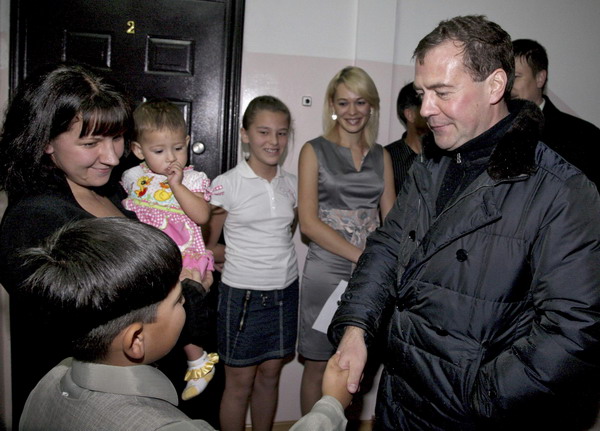 Russia's President Dmitry Medvedev (R) visits a local family during his tour of Kunashiri Island on November 1, 2010.