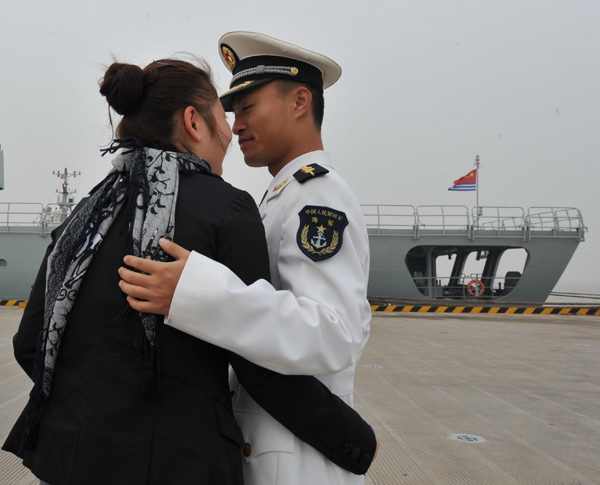 A navy officer says goodbye to his wife in Zhoushan, East China&apos;s Zhejiang province, before leaving for escort missions in the Gulf of Aden and Somali waters, Nov 2, 2010. [Xinhua]