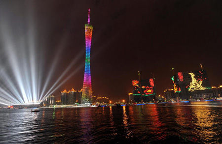 Canton Tower is lit up by neon lights in Guangzhou on Oct 20, 2010. As the Asian Games approaches, the host city Guangzhou is illuminated at night as buildings in downtown areas are decorated with many Asiad-themed neon lights. (Photo/Xinhua) 