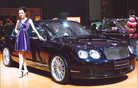 A model poses next to a Bentley Motors Limited vehicle at the 2009 Shanghai auto show. The company expects its annual sales in China this year to be at least double the figure in 2009 and probably hit 1,000. 