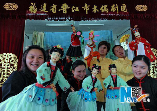 Actors of the Jinjiang Puppet Troupea rehearse a puppet show. 