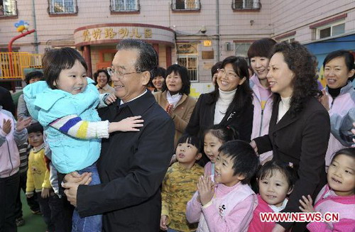 Chinese Premier Wen Jiabao (2nd L, front) chats with children at Hufanglu Kindergarten during an inspection over pre-school education in the downtown area of Beijng, capital of China, Nov. 2, 2010.[Photo/Xinhua]