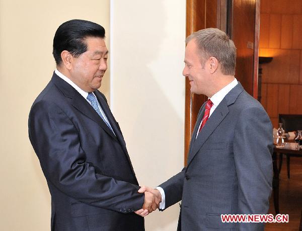 Jia Qinglin (L), chairman of the Chinese People's Political Consultative Conference (CPPCC) National Committee, meets with Polish Prime Minister Donald Tusk in Warsaw, Poland, Nov. 3, 2010. [Wu Wei/Xinhua]