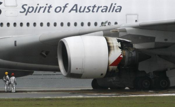 Qantas Airways A-380 passenger plane QF32 with its partially damaged engine sits on the tarmac after making an emergency landing at Changi airport in Singapore November 4, 2010. [Xinhua]