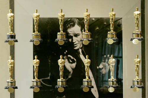A photograph of the late actor Marlon Brando is framed by a portion of the Academy Awards bestowed upon films from movie studio Metro-Goldwyn-Mayer Inc., on display at the studio's Los Angeles office in this March 8, 2006 file photo. Metro-Goldwyn-Mayer Studios Inc filed for bankruptcy on November 3, 2010, marking a climax to a drawn-out restructuring for the storied Hollywood studio that controls the James Bond films and made 'The Wizard of Oz. [China Daily via agencies]