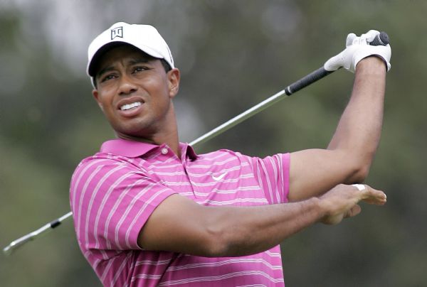 Woods lets go of his club during the first round of the BMW Championship golf tournament in Lemont Tiger Woods of the U.S. lets go of his club after hitting a tee shot on the eighth hole during the first round of the BMW Championship golf tournament in Lemont, Illinois September 9, 2010. (Xinhua/Reuters)