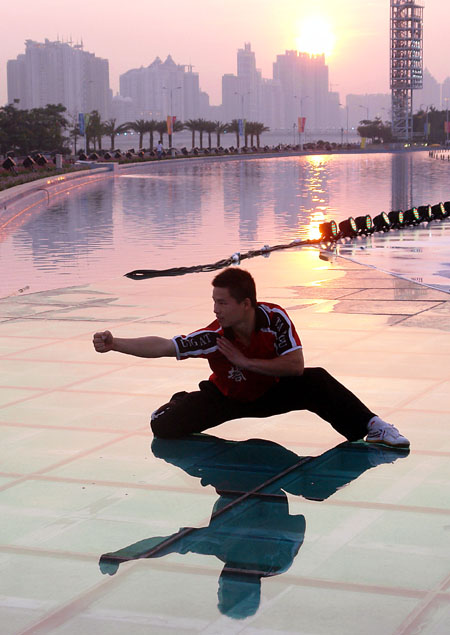 A student from Shaolin Tagou Martial Arts School practices on a square in Guangzhou, South China&apos;s Guangdong province, Nov 7, 2010. [Xinhua]