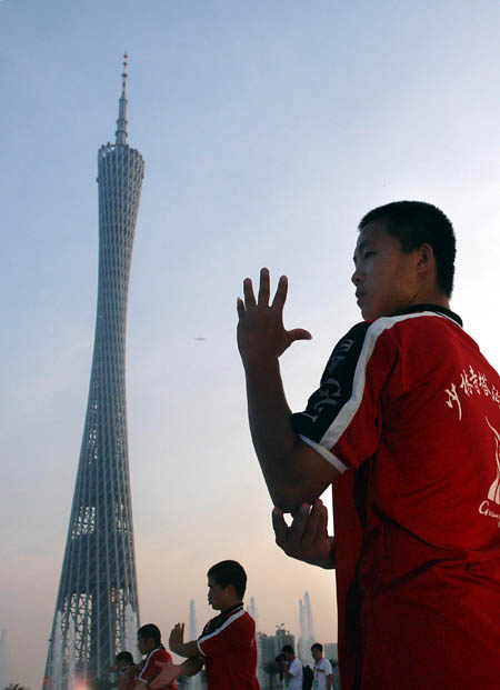 Students from Shaolin Tagou Martial Arts School practice on a square in Guangzhou, South China&apos;s Guangdong province, Nov 7, 2010. [Xinhua] 
