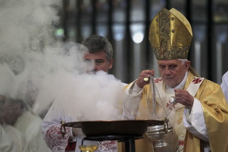 Pope Benedict XVI spreads incense as he celebrates a mass to consecrate La Sagrada Familia church in Barcelona November 7, 2010. 