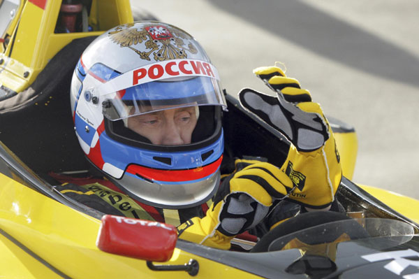 Russia&apos;s Prime Minister Vladimir Putin sits in a car from the Renault Formula One team before test driving it at a racing track in Leningrad Region, November 7, 2010. [China Daily/Agencies] 