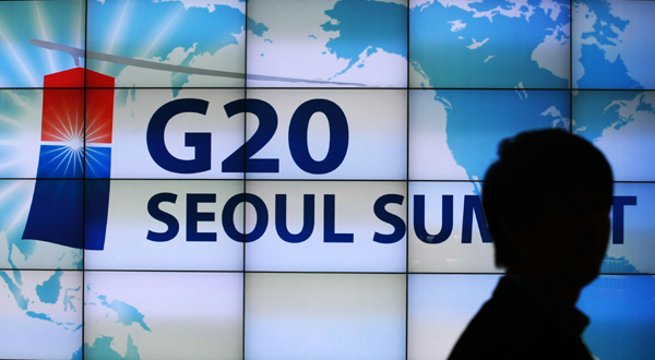 A man walks past a signboard promoting the upcoming G20 Seoul Summit at the venue for the summit in Seoul, capital of South Korea on Nov. 4, 2010. The G20 Seoul Summit is to be held here from Nov. 11 through 12. [Park Jin-hee/Xinhua]