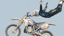 A cycler performs in the air with a motorbike during the final of the 2010 National Cross-Country Motorcycle Championships in Wuyi County, east China's Zhejiang Province, Nov. 7, 2010.