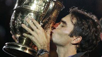 Swiss Roger Federer kisses the trophy after defeating Serbian Novak Djokovic 6-4, 3-6, 6-1 during the Swiss Indoors ATP tennis tournament final match in Basel.