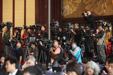 A large group of media professionals cover a press conference in Beijing. Investigative journalists say they are constantly under threat and are asking for better protection.