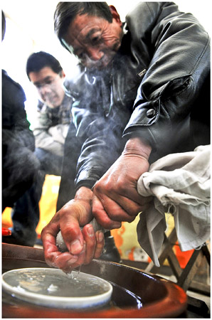 A miner dries his booty, ready to weigh near the city of Yuncheng in Shanxi Province on July 22.