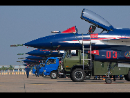 J-10 jet fighters with new coating are seen at the Sanzao Airport in Zhuhai, south China's Guangdong Province, Nov. 8, 2010. [Xinhua]