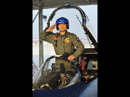 Cao Zhen, the captain of China's Bayi Aerobatic Team, salutes on a J-10 jet fighter in Tianjin, east China, Nov. 5, 2010. [Xinhua]