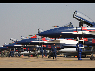 J-10 jet fighters with new coating are seen at the Sanzao Airport in Zhuhai, south China's Guangdong Province, Nov. 8, 2010. [Xinhua]