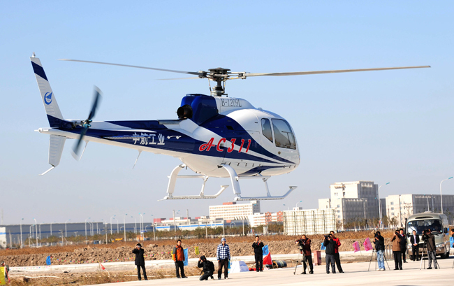 An AC311 (Front)and an AC 301 helicopter. [Xinhua]