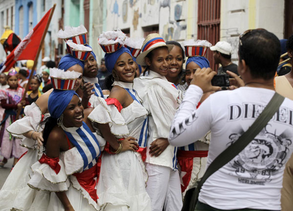 Dancers dressed in the colors of the Cuban flag pose for pictures during an AIDS awareness event in Havana on November 7, 2010. Several hundred residents of a Havana neighbourhood gathered to play music and dance along the streets in the event sponsored and organized by the Cuban Ministry of Health (MINSAP) and the United Nations Development Programme (UNDP) aimed at promoting AIDS awareness and tolerance of same sex relationships. [China Daily/Agencies]